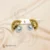 golden stud half circle shape with white pearl