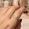 gold-plated anti-tarnish stainless steel clover-themed ring with a white center stone