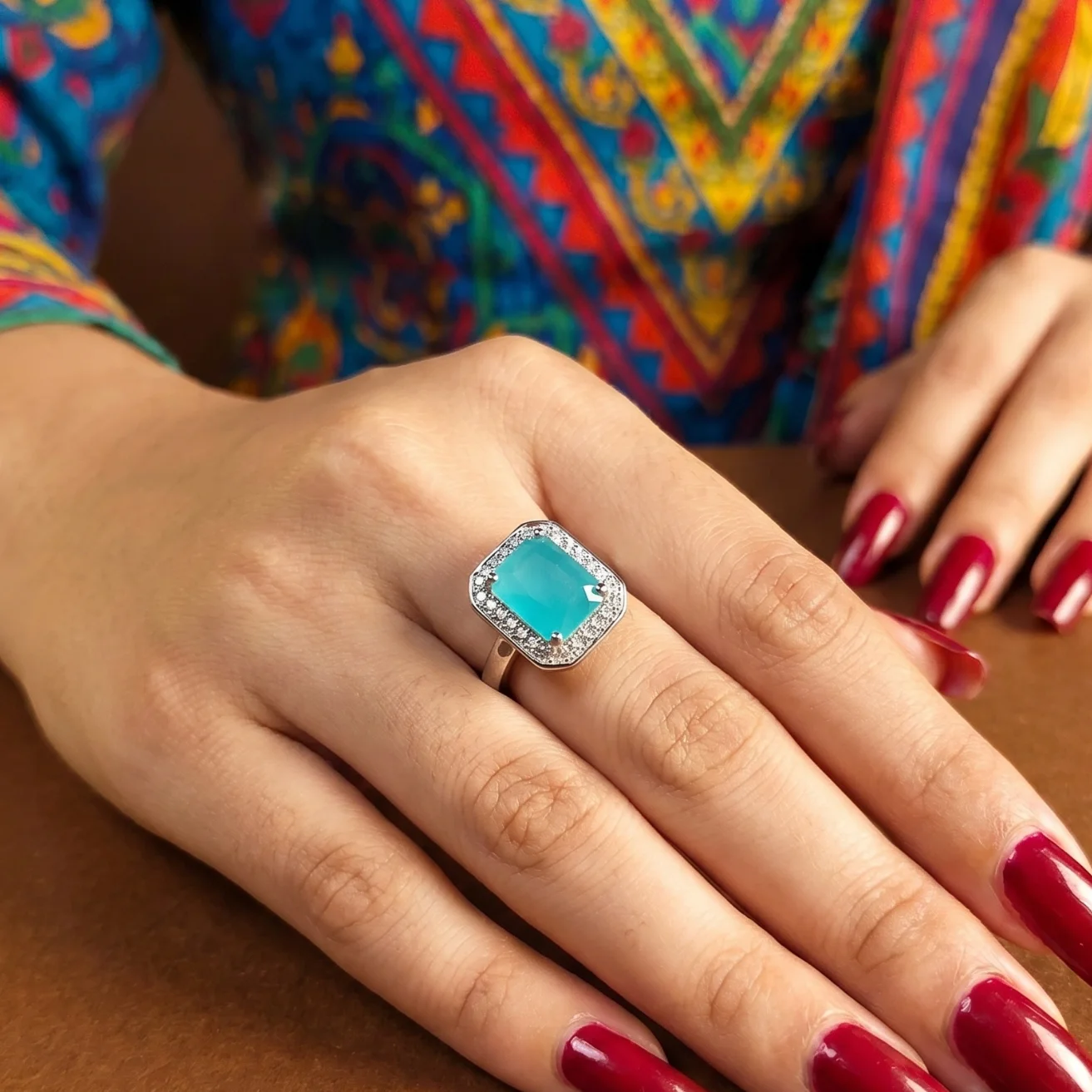 Sea green emerald-cut ruby halo ring