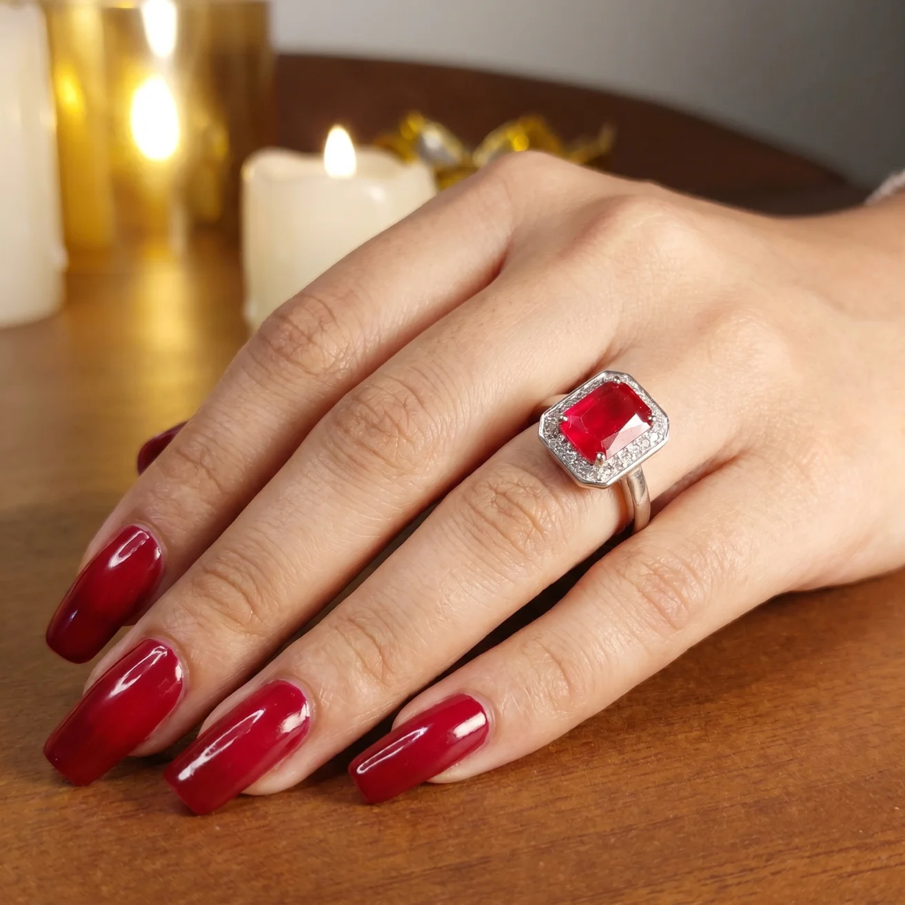 Red emerald-cut ruby halo ring